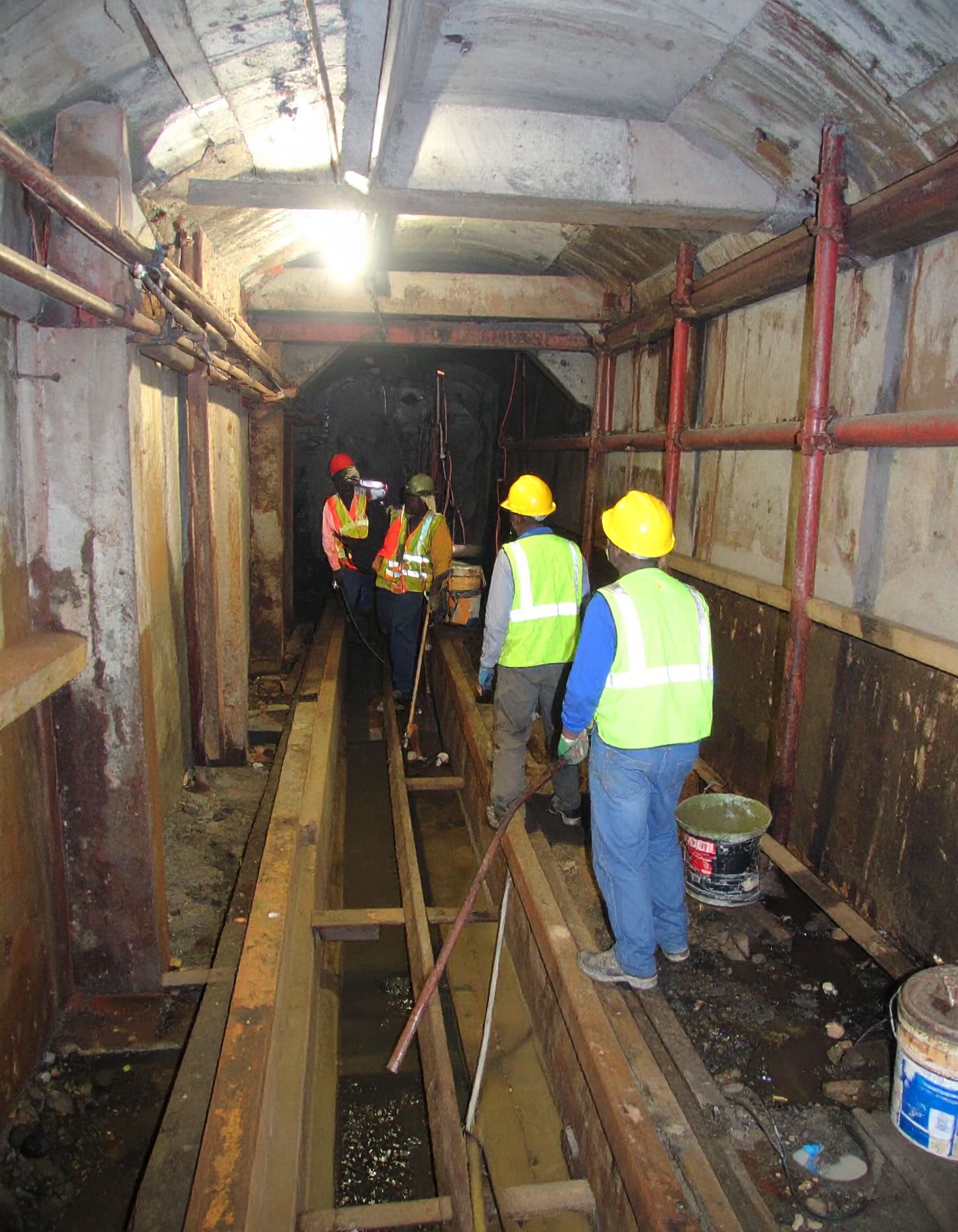 Firefly_A realistic image of African technicians performing lift shaft waterproofing at a com 94726