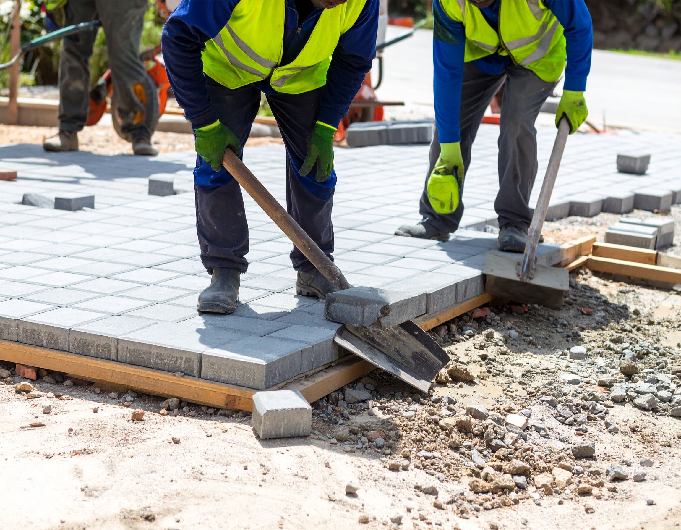 Firefly_A realistic image showing African workers installing cabro paving blocks on a drivewa 324721